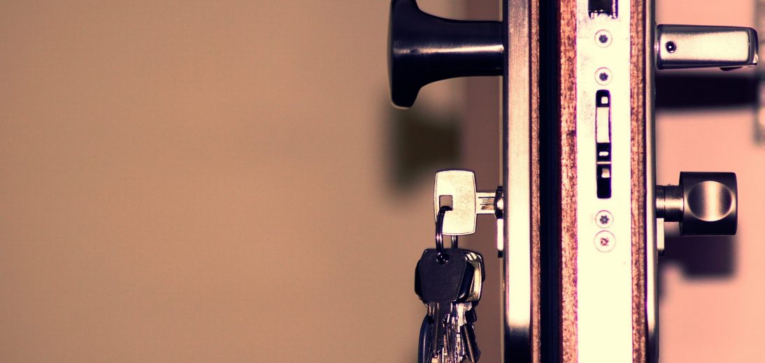 A key in a lock on an open door
